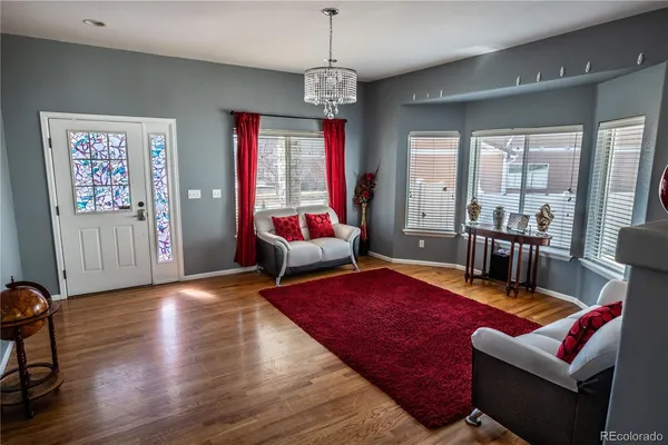 a living room with furniture rug and window