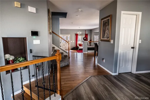a view of entryway with wooden floor and stairs