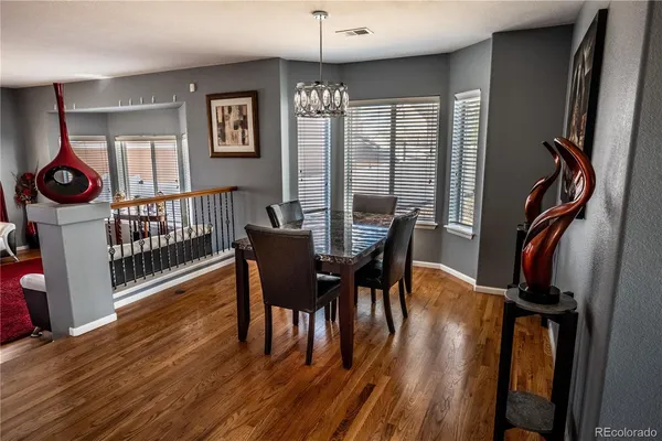 a view of a dining room with furniture window and wooden floor