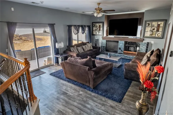 a living room with furniture flat screen tv and a fireplace