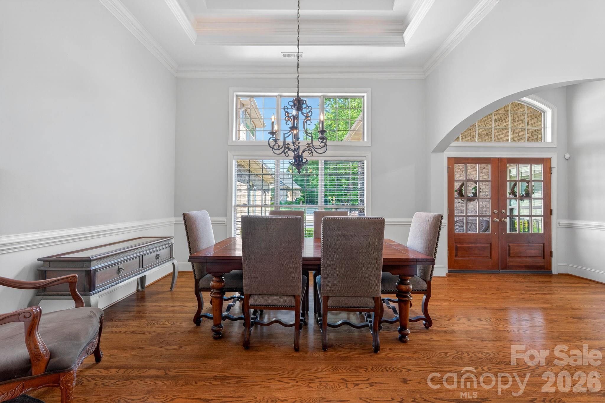 3138 Rappahannock Court, Unit 16 Matthews, NC 28104 - Photo 13 of 38 a view of a dining room with furniture a chandelier and wooden floor