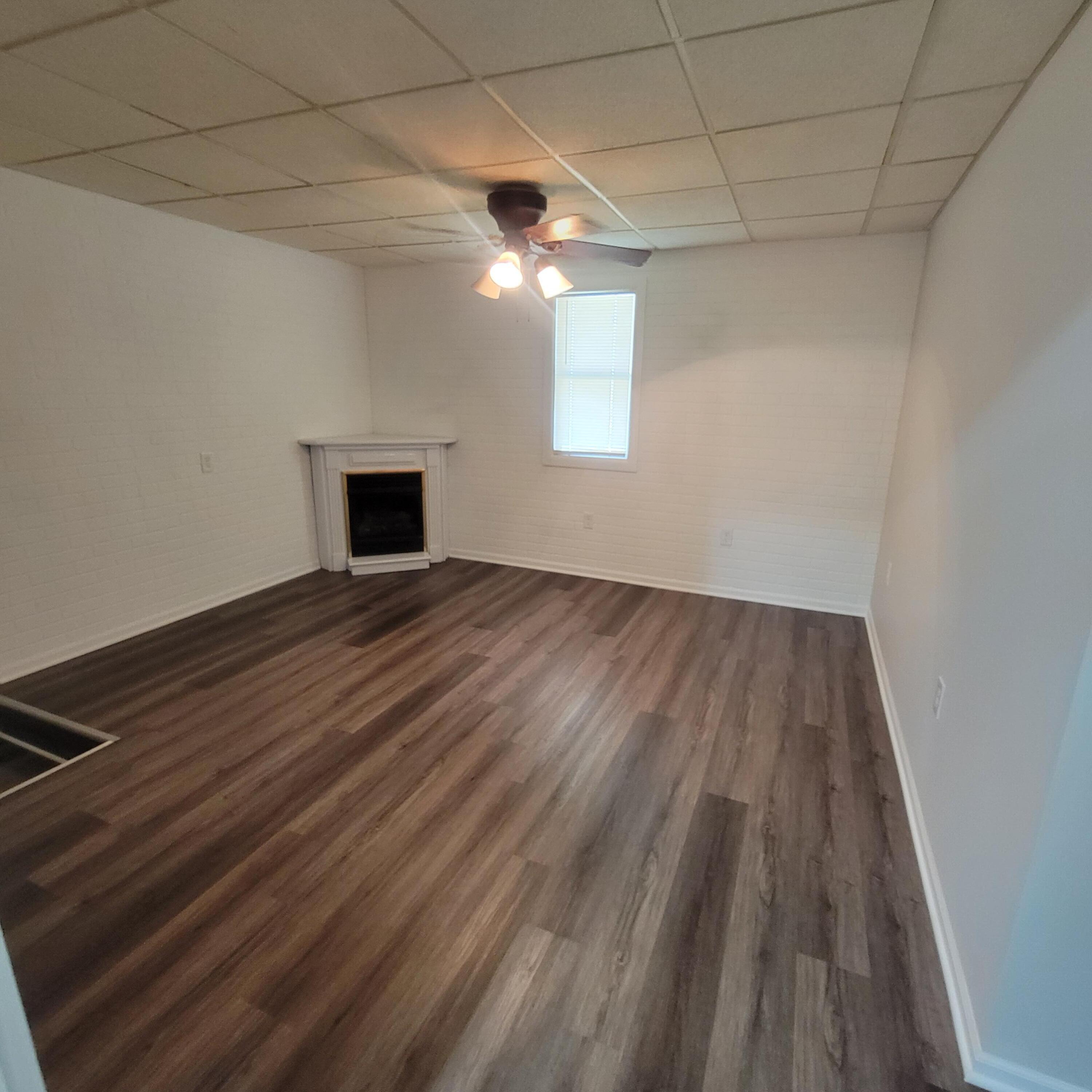 6676 Lakewood Avenue Portage, IN 46368 - Photo 12 of 14 a view of empty room with wooden floor and fireplace