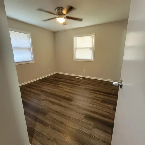 a view of room with window and ceiling fan