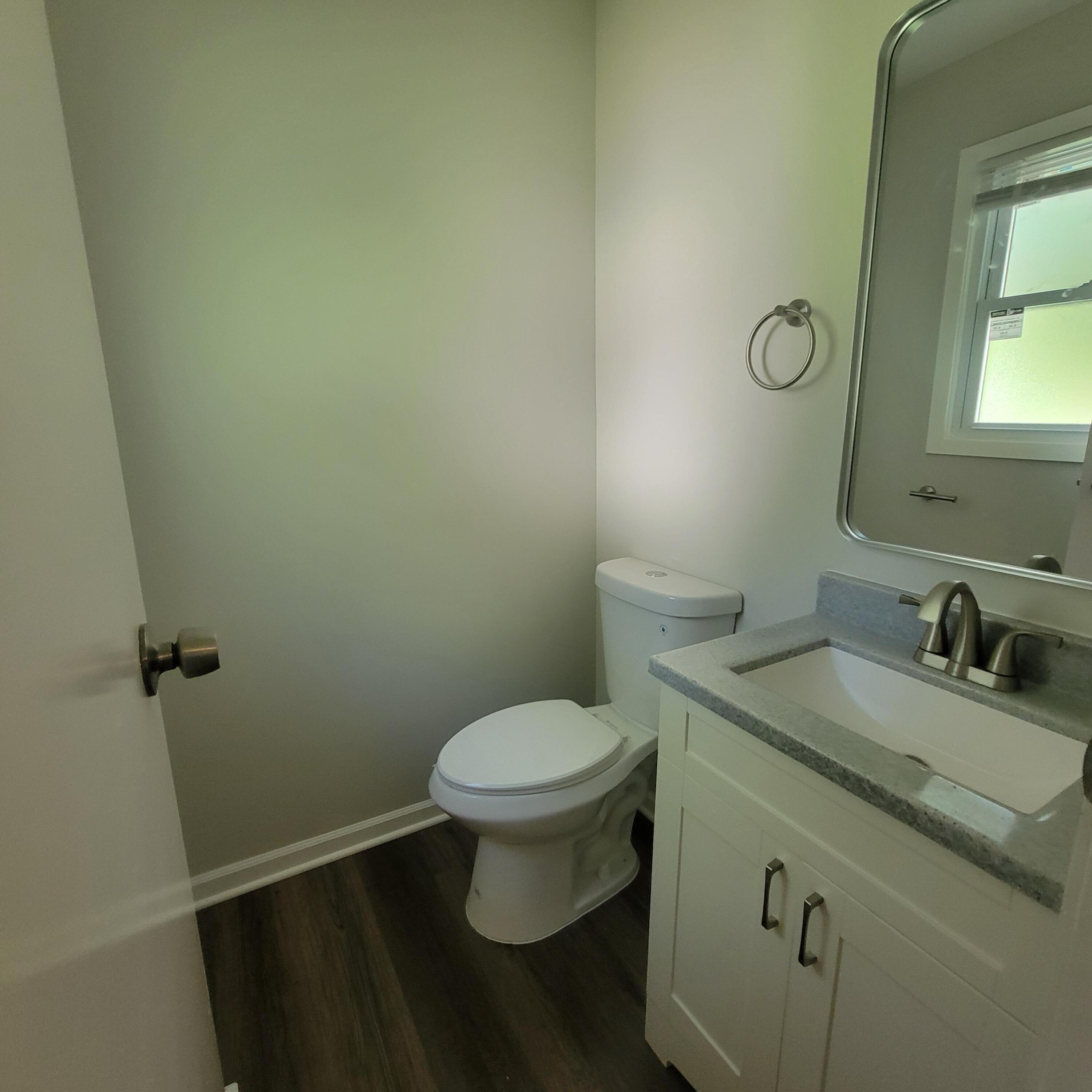 6676 Lakewood Avenue Portage, IN 46368 - Photo 9 of 14 a bathroom with a granite countertop toilet and a sink