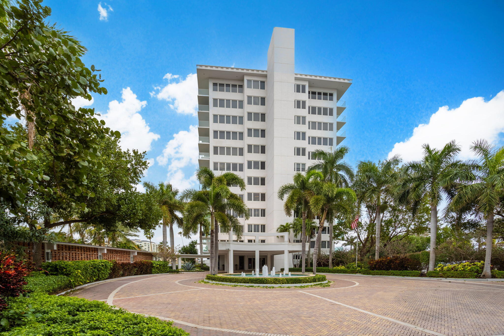 701 East Camino Real, Unit 8F Boca Raton, FL 33432 - Photo 2 of 54 a front view of a building with a garden