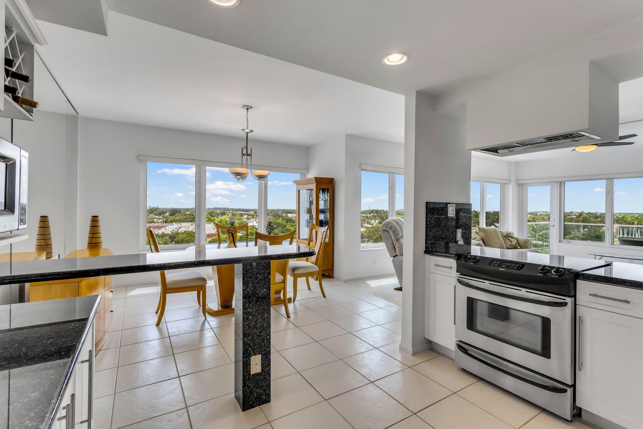 701 East Camino Real, Unit 8F Boca Raton, FL 33432 - Photo 29 of 54 a kitchen with stainless steel appliances granite countertop a stove and cabinets