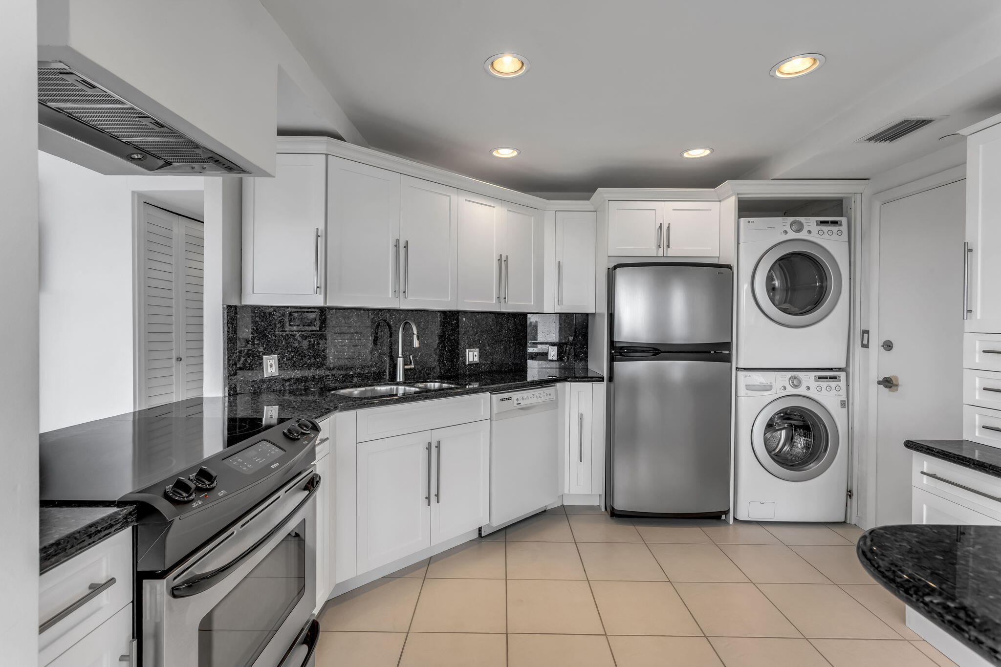 701 East Camino Real, Unit 8F Boca Raton, FL 33432 - Photo 30 of 54 a kitchen with a sink a stove top oven and cabinets