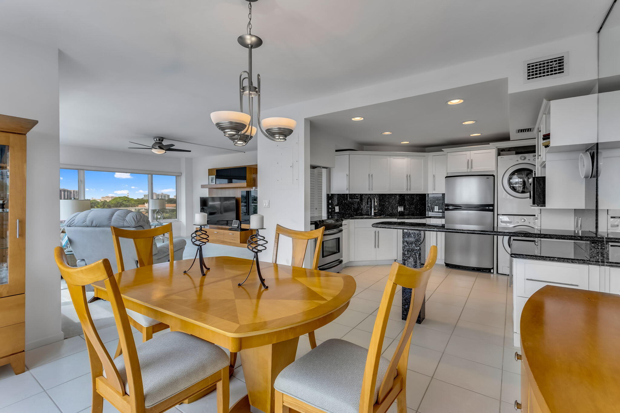 701 East Camino Real, Unit 8F Boca Raton, FL 33432 - Photo 33 of 54 a view of a dining room and livingroom with furniture wooden floor a chandelier