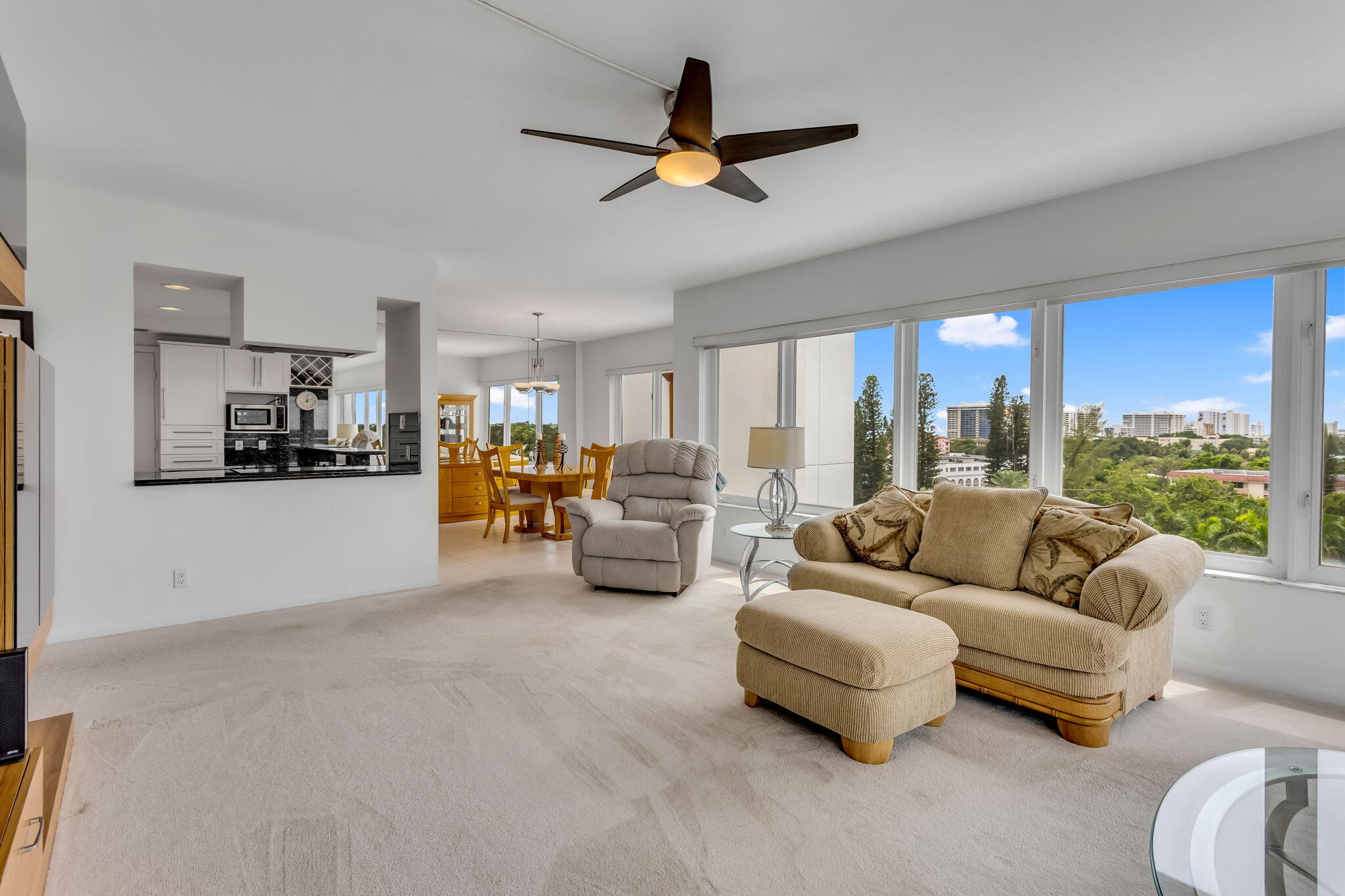 701 East Camino Real, Unit 8F Boca Raton, FL 33432 - Photo 36 of 54 a living room with furniture kitchen area and a large window