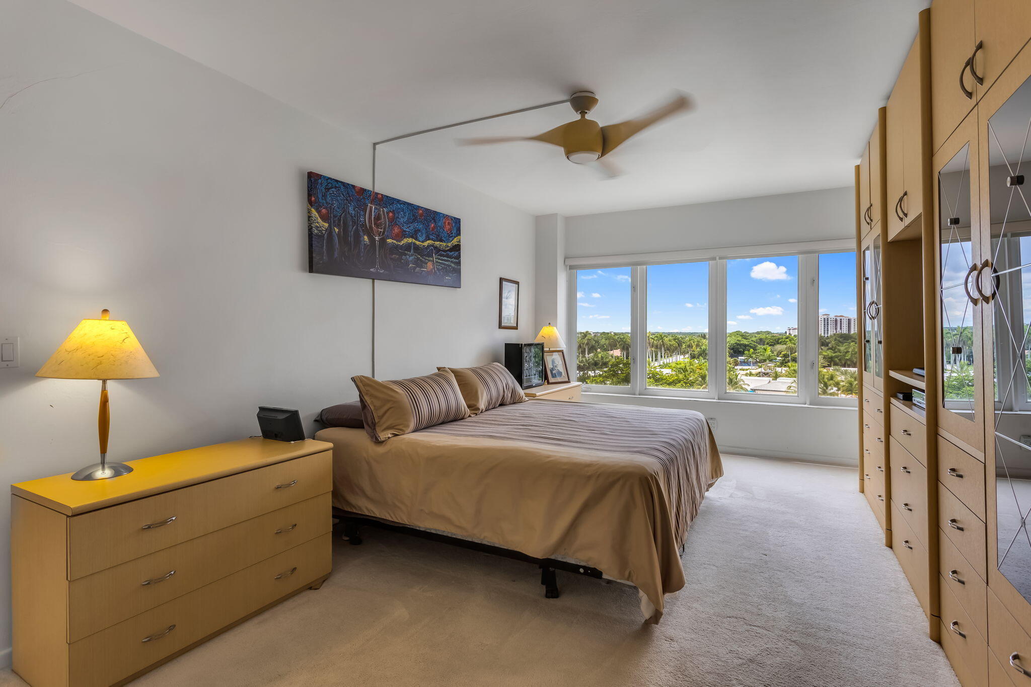 701 East Camino Real, Unit 8F Boca Raton, FL 33432 - Photo 42 of 54 a bedroom with a bed and a lamp