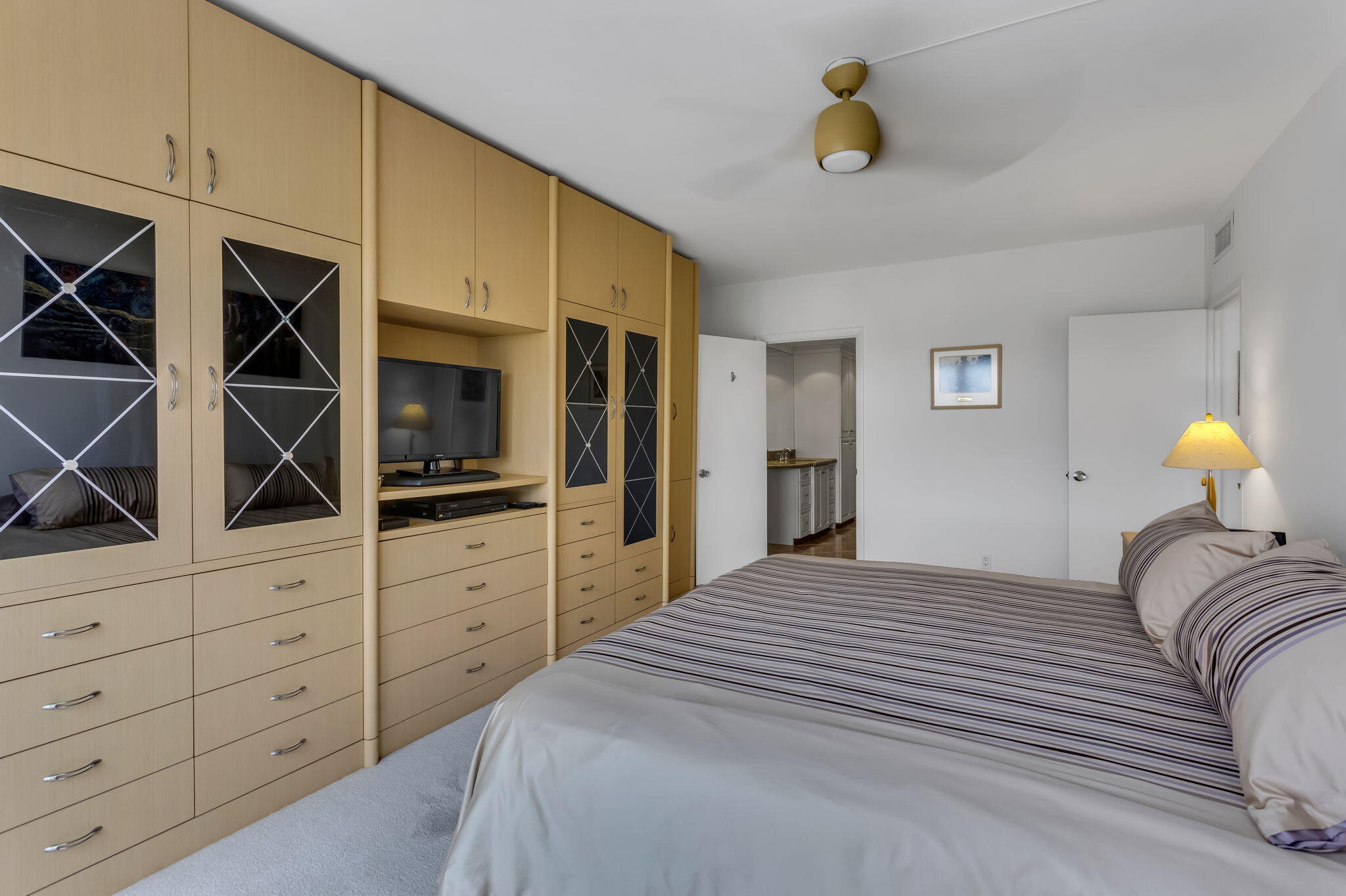 701 East Camino Real, Unit 8F Boca Raton, FL 33432 - Photo 44 of 54 a bedroom with a bed and cabinets