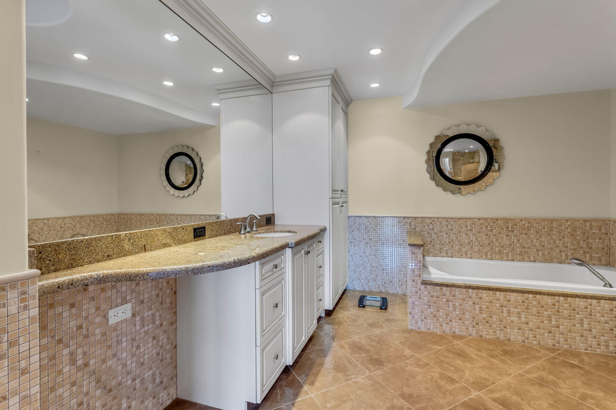 701 East Camino Real, Unit 8F Boca Raton, FL 33432 - Photo 45 of 54 a bathroom with a granite countertop sink and a large mirror