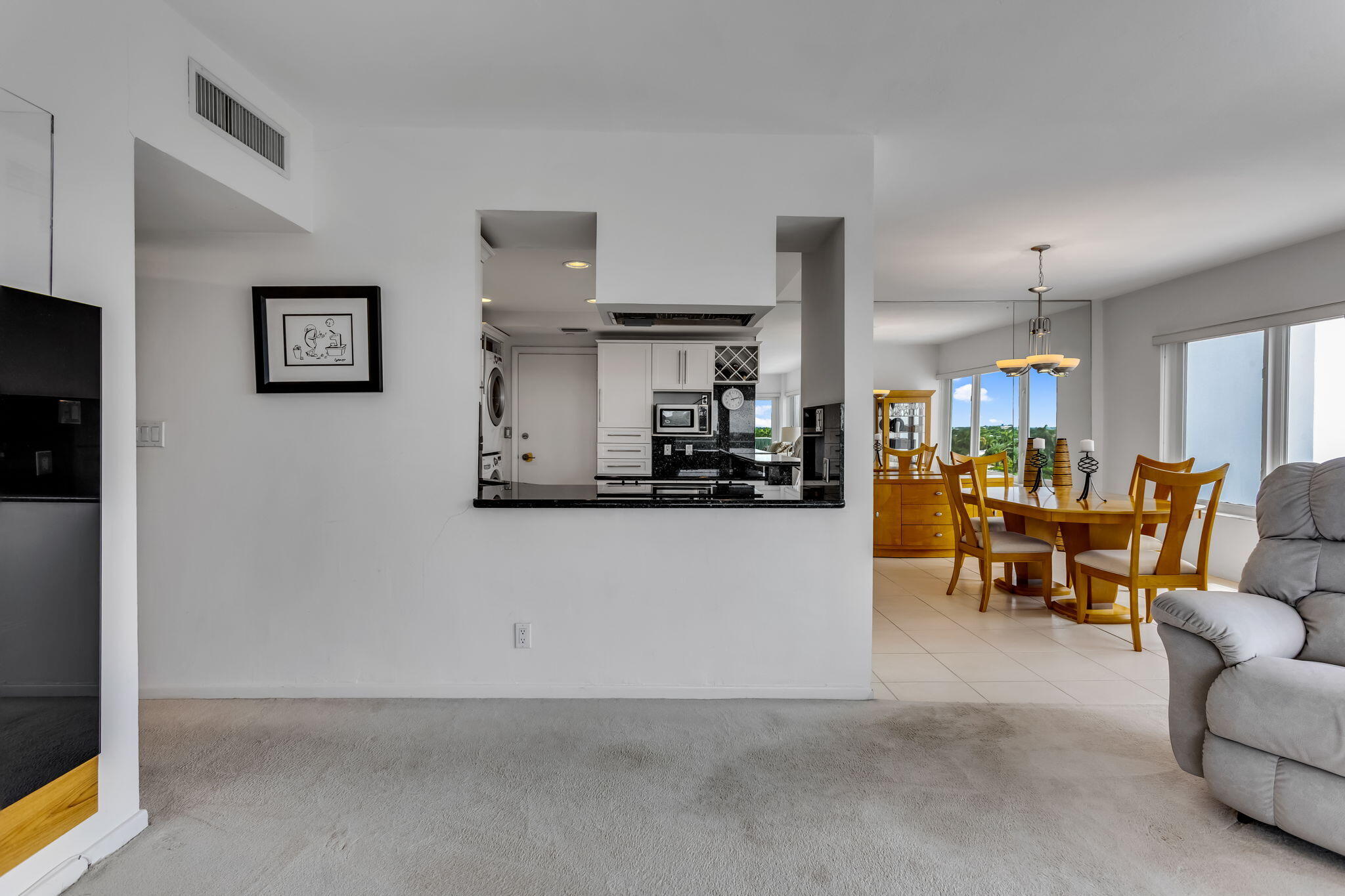 701 East Camino Real, Unit 8F Boca Raton, FL 33432 - Photo 50 of 54 a living room with furniture and a flat screen tv