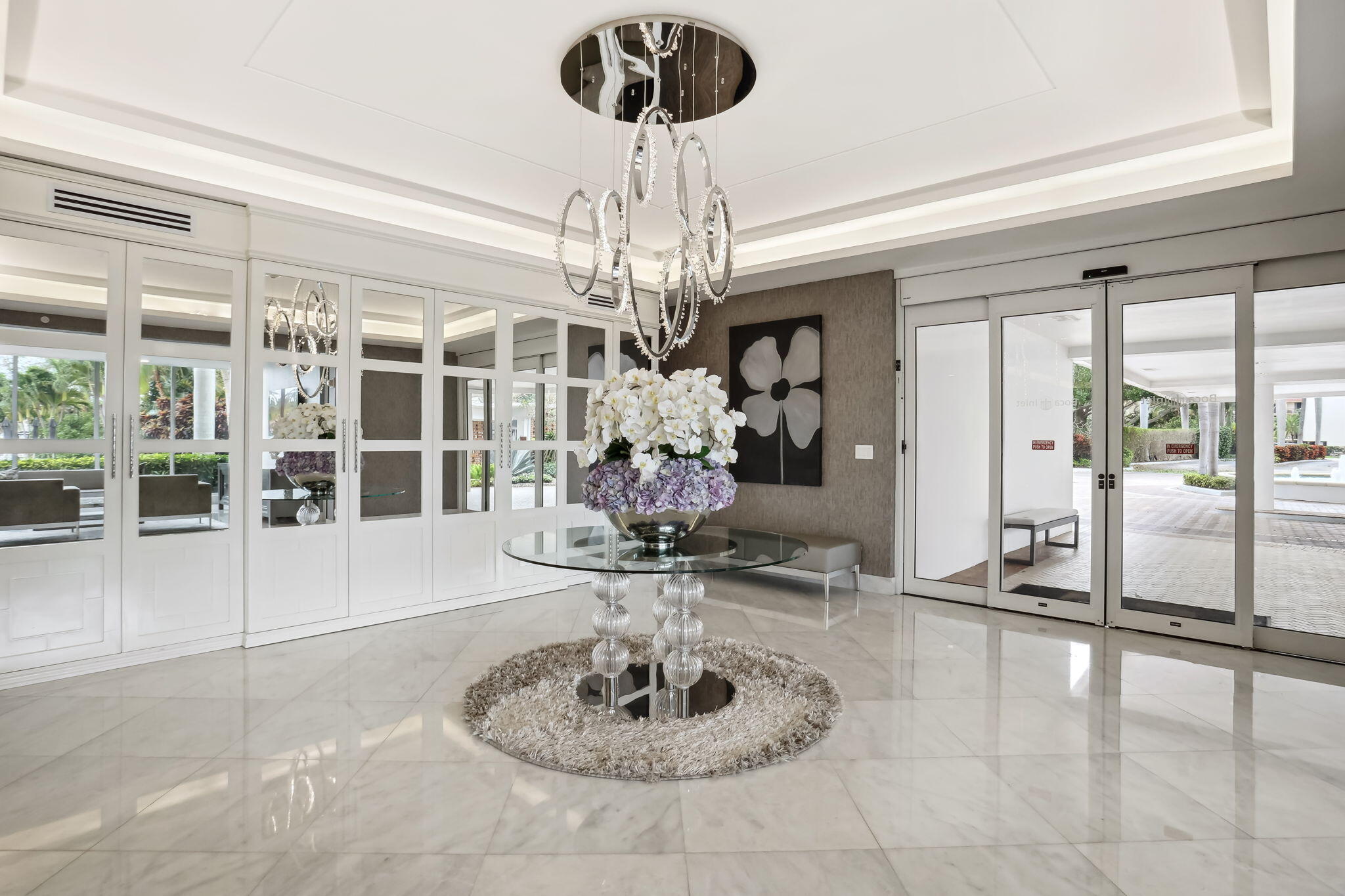 701 East Camino Real, Unit 8F Boca Raton, FL 33432 - Photo 8 of 54 a view of a lobby with furniture and chandelier