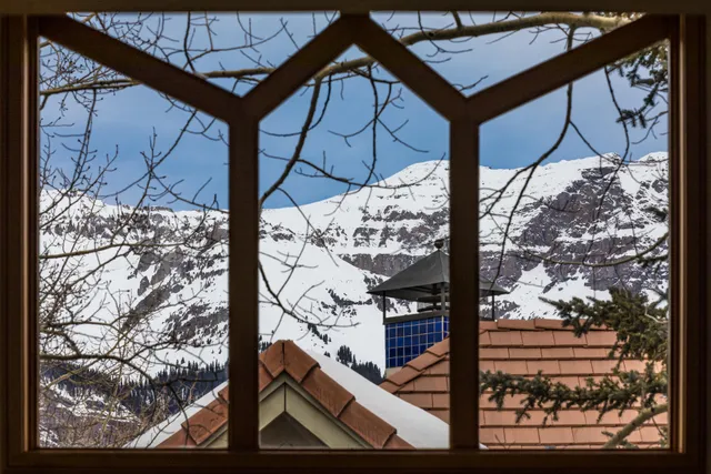 a bedroom with a bed and a window with couch