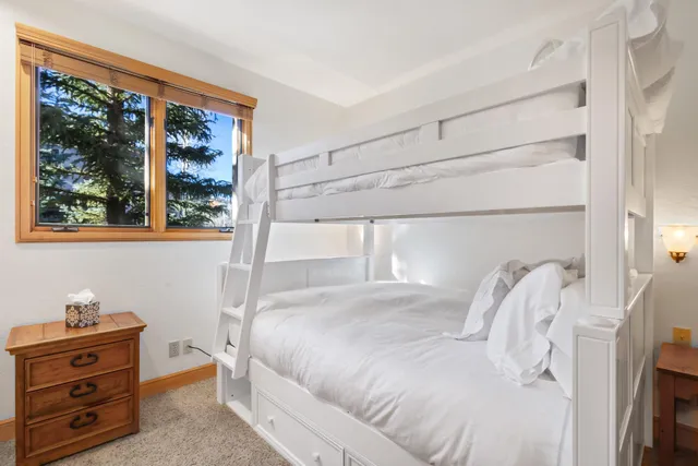 a view of a hallway with stairs and a window
