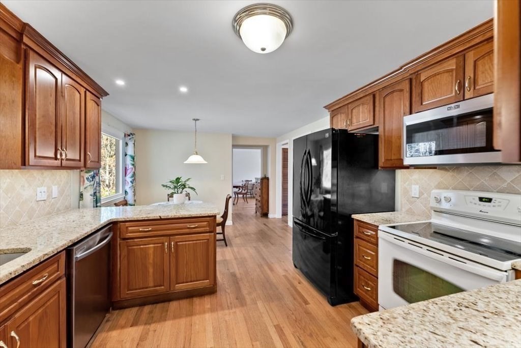 38 Blacksmith Road Wilbraham, MA 01095 - Photo 13 of 39 a kitchen with stainless steel appliances granite countertop a sink stove and refrigerator