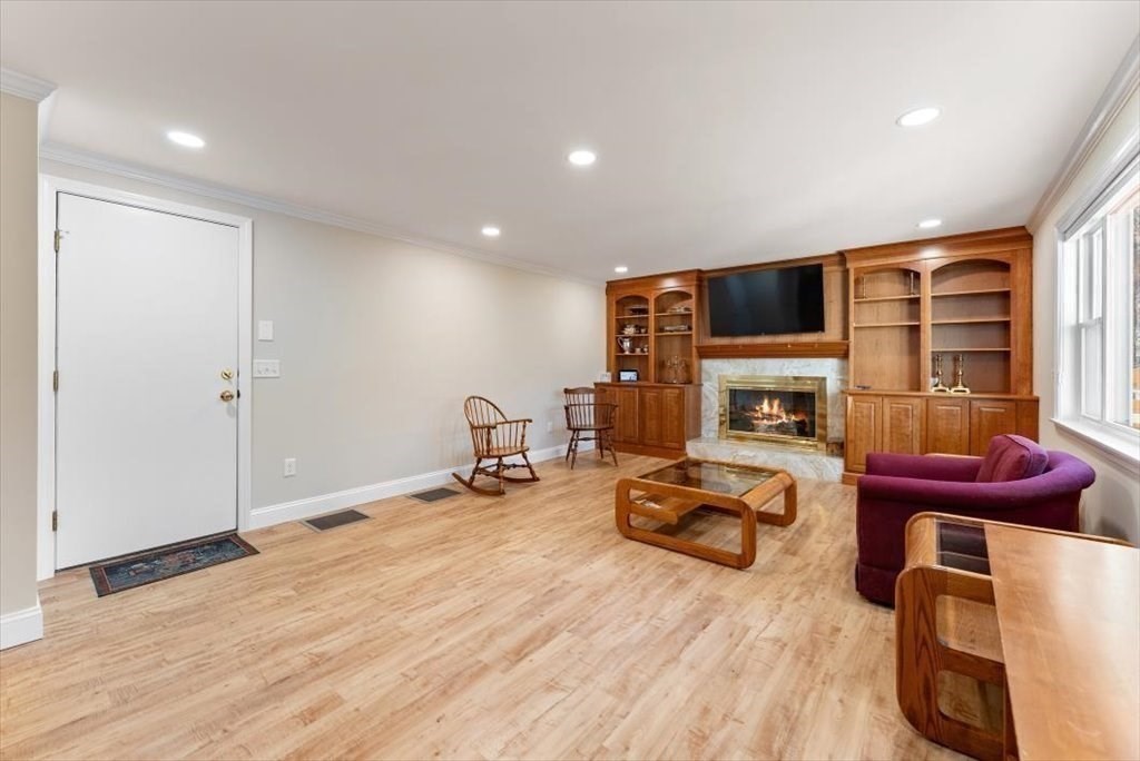 38 Blacksmith Road Wilbraham, MA 01095 - Photo 15 of 39 a living room with furniture a fireplace and a flat screen tv