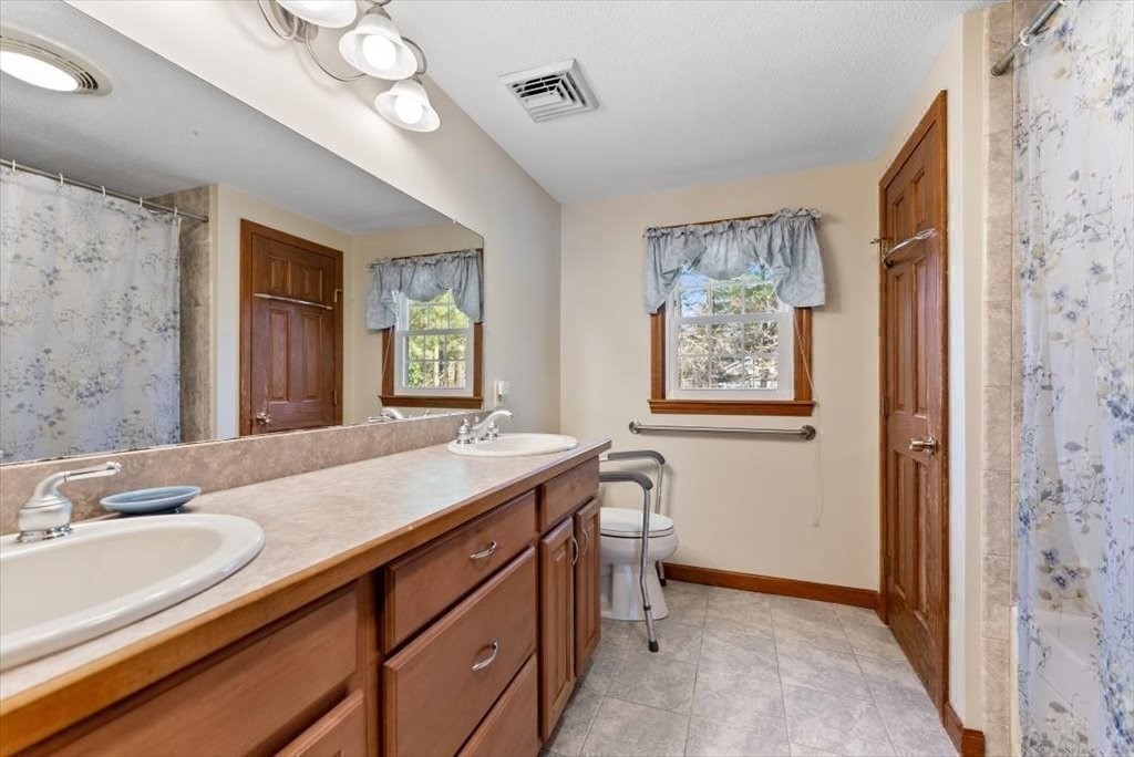38 Blacksmith Road Wilbraham, MA 01095 - Photo 34 of 39 a bathroom with a granite countertop sink a mirror a vanity and a window
