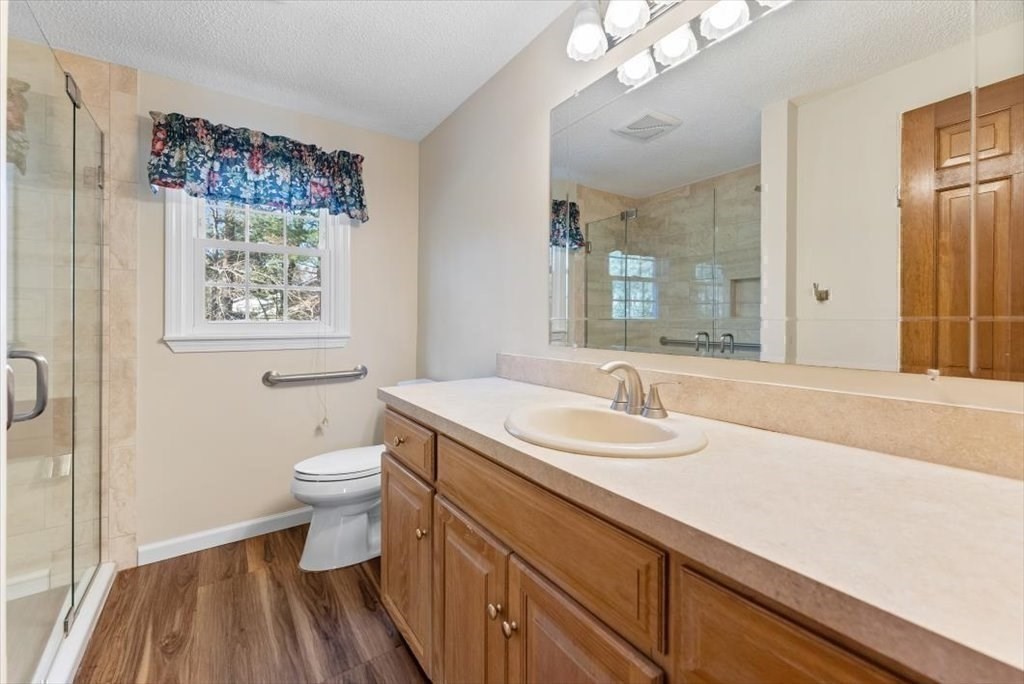 38 Blacksmith Road Wilbraham, MA 01095 - Photo 36 of 39 a bathroom with a sink a toilet and a mirror