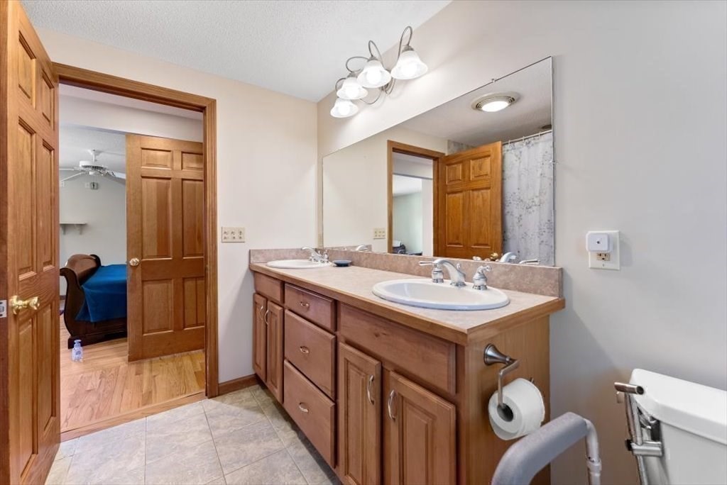 38 Blacksmith Road Wilbraham, MA 01095 - Photo 37 of 39 a bathroom with a sink double vanity and a mirror