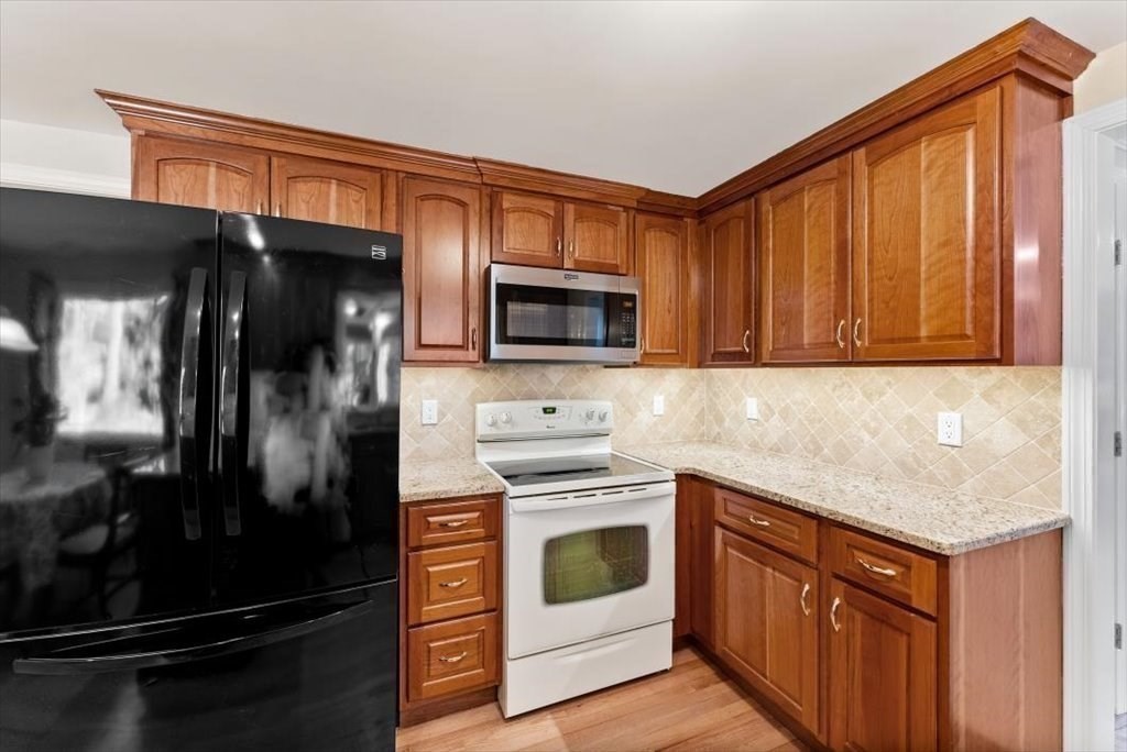 38 Blacksmith Road Wilbraham, MA 01095 - Photo 8 of 39 a kitchen with stainless steel appliances granite countertop a stove microwave and refrigerator