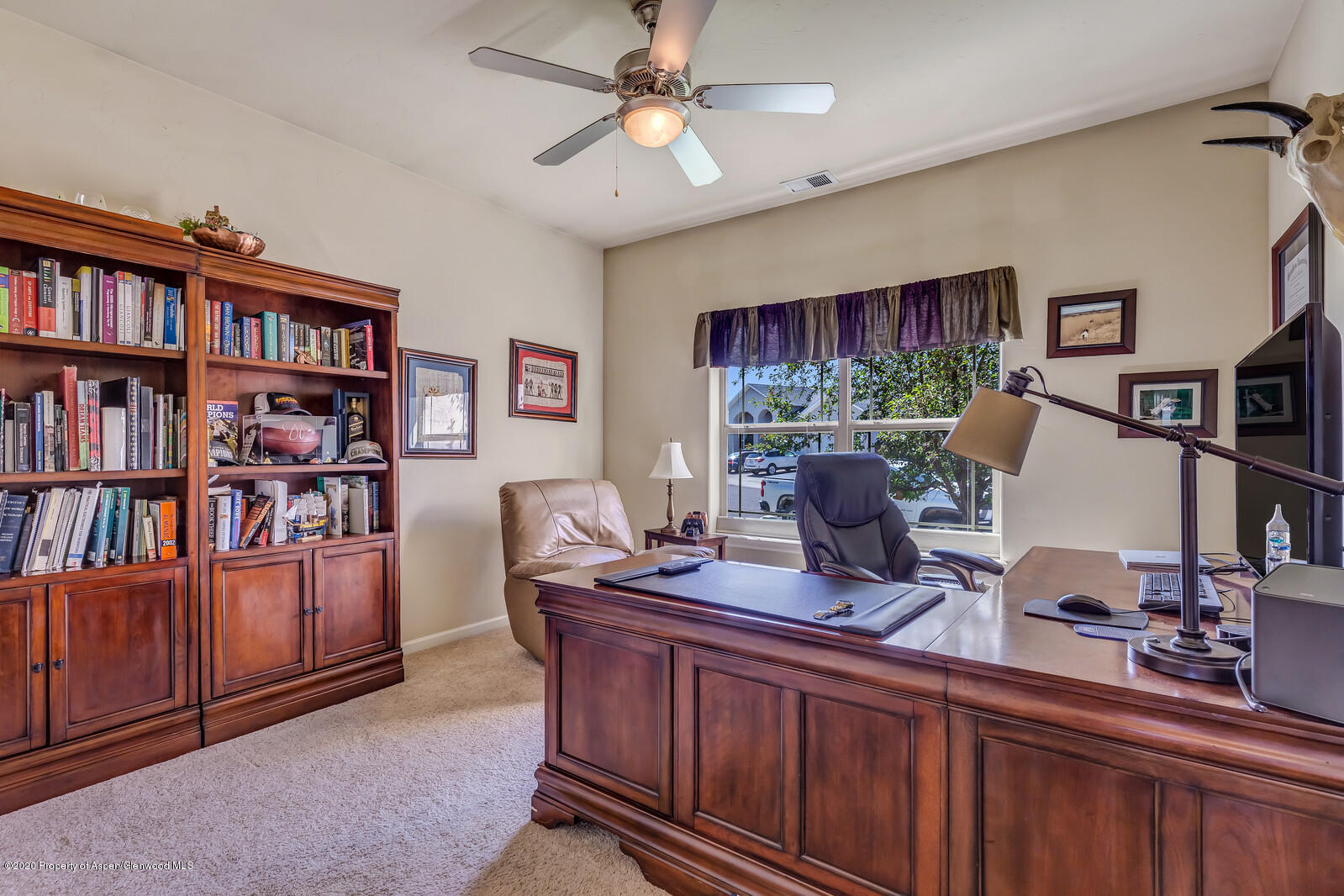 952 East 18th Street Rifle, CO 81650 - Photo 15 of 26 a view of a workspace with furniture and a bookshelf