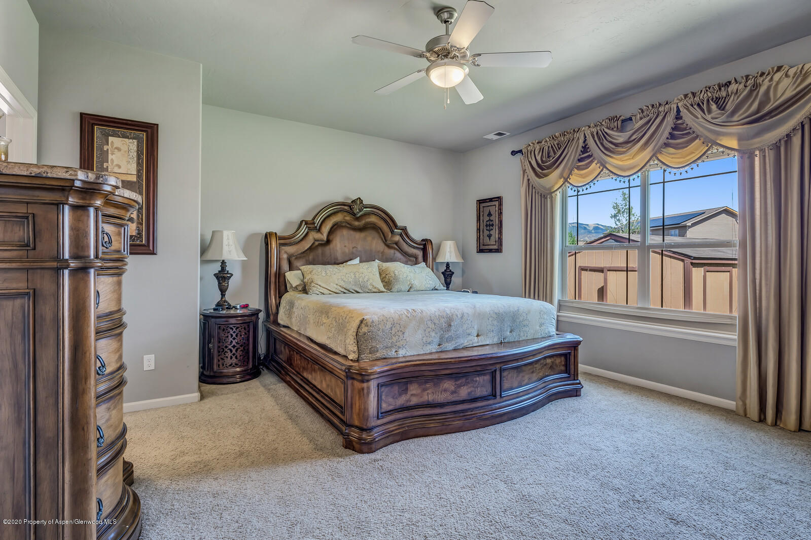 952 East 18th Street Rifle, CO 81650 - Photo 16 of 26 a bedroom with a bed and a chandelier