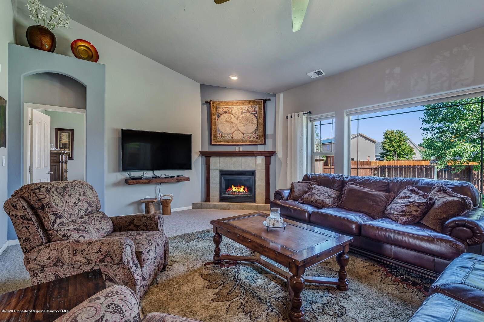 952 East 18th Street Rifle, CO 81650 - Photo 8 of 26 a living room with furniture flat screen tv and a fireplace