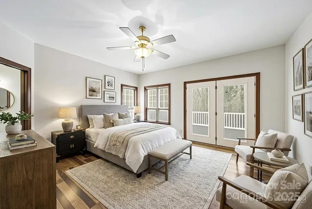 a spacious bedroom with a bed a couch and a large window