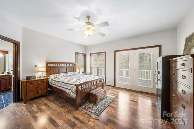 a living room with a bed furniture and a flat tv screen