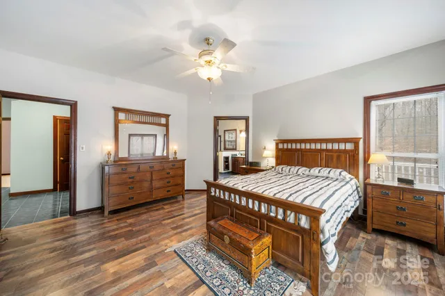a bedroom with a bed window and a dresser