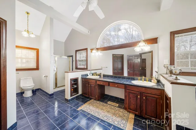 a large bathroom with a sink a toilet and a mirror