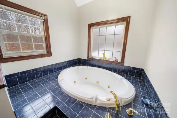a view of washer and dryer with bathroom in the background