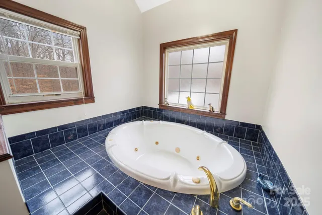 a view of washer and dryer with bathroom in the background