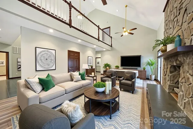 a living room with furniture a flat screen tv and a fireplace