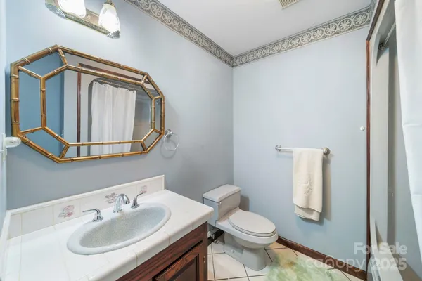 a bathroom with a sink a mirror and a toilet