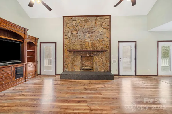 a view of a livingroom with wooden floor and a flat screen tv