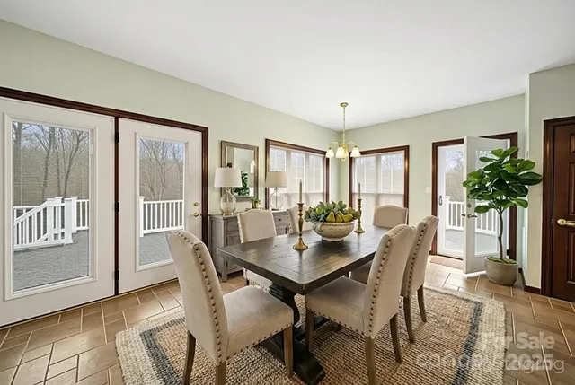 a view of a dining room with furniture and a potted plant