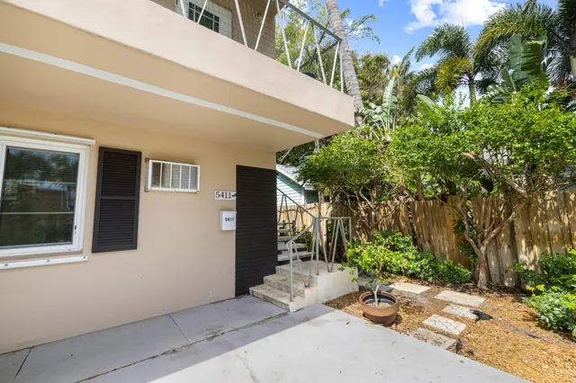 a backyard of a house with plants and trees