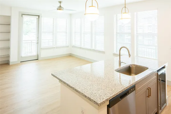 a kitchen with granite countertop a sink and a window
