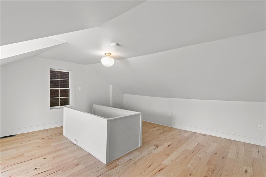 2011 Forbes Avenue Pittsburgh, PA 15219 - Photo 31 of 41 a view of an empty room with wooden floor and a window