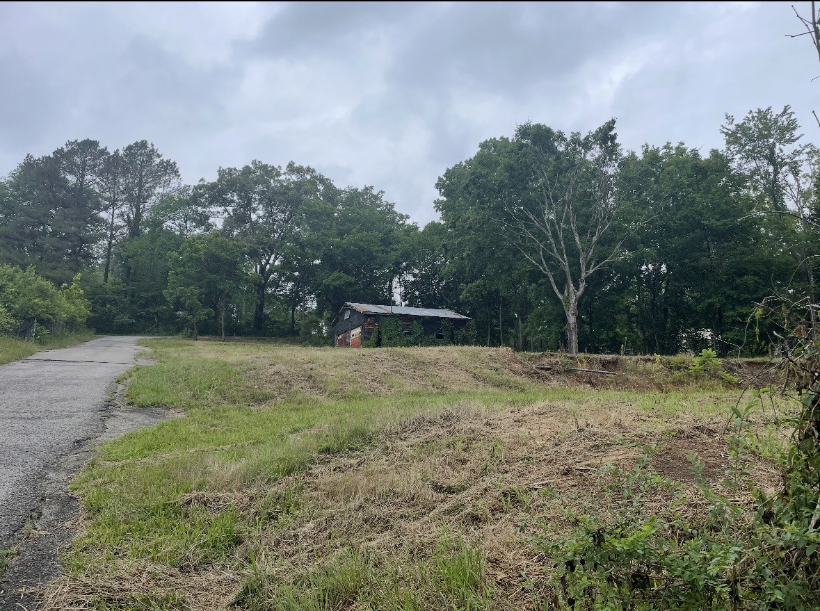 1586 River Road Clarksville, TN 37040 - Photo 1 of 1 a backyard of a house with trees and a house in the background