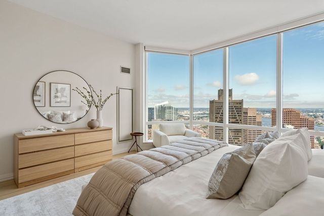 a bedroom with bed a balcony a bed and a couch