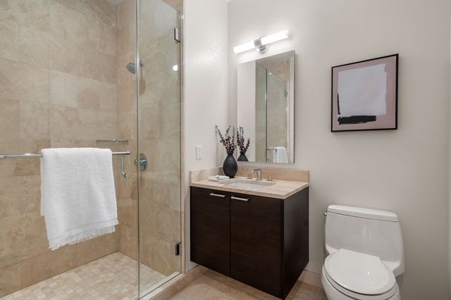 a large bathroom with a double vanity sink a mirror and a bathtub