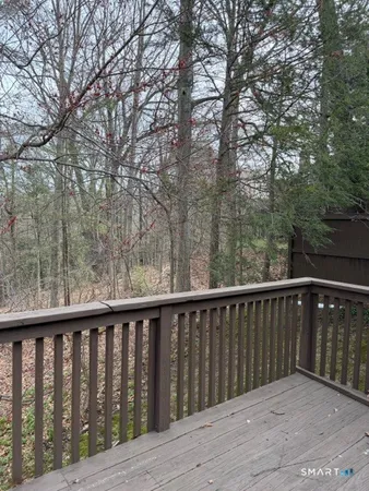 a balcony with wooden floor and fence
