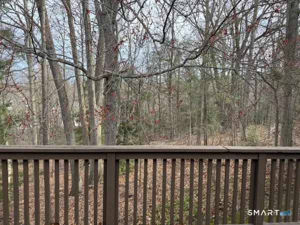 a balcony with trees in front of it