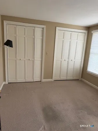 a view of an empty room and a window