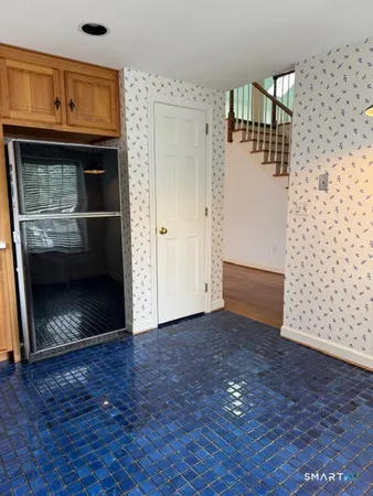 a view of empty room with wooden floor and fireplace