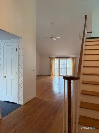 a view of entryway with wooden floor and stairs